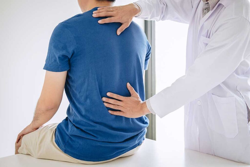 Person lifting a storage box with bent knees, a neutral spine, and the box held close to the body.